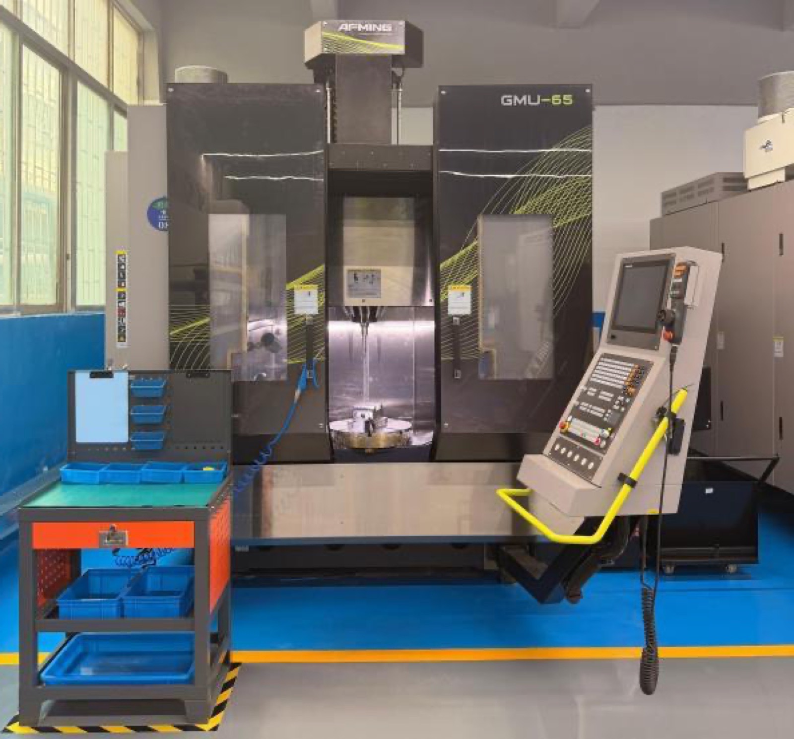 An AEMING five-axis machining centre (GMU-65) on the Fudakin shop floor, cutting a part